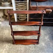 Curved and turned wooden wall shelf