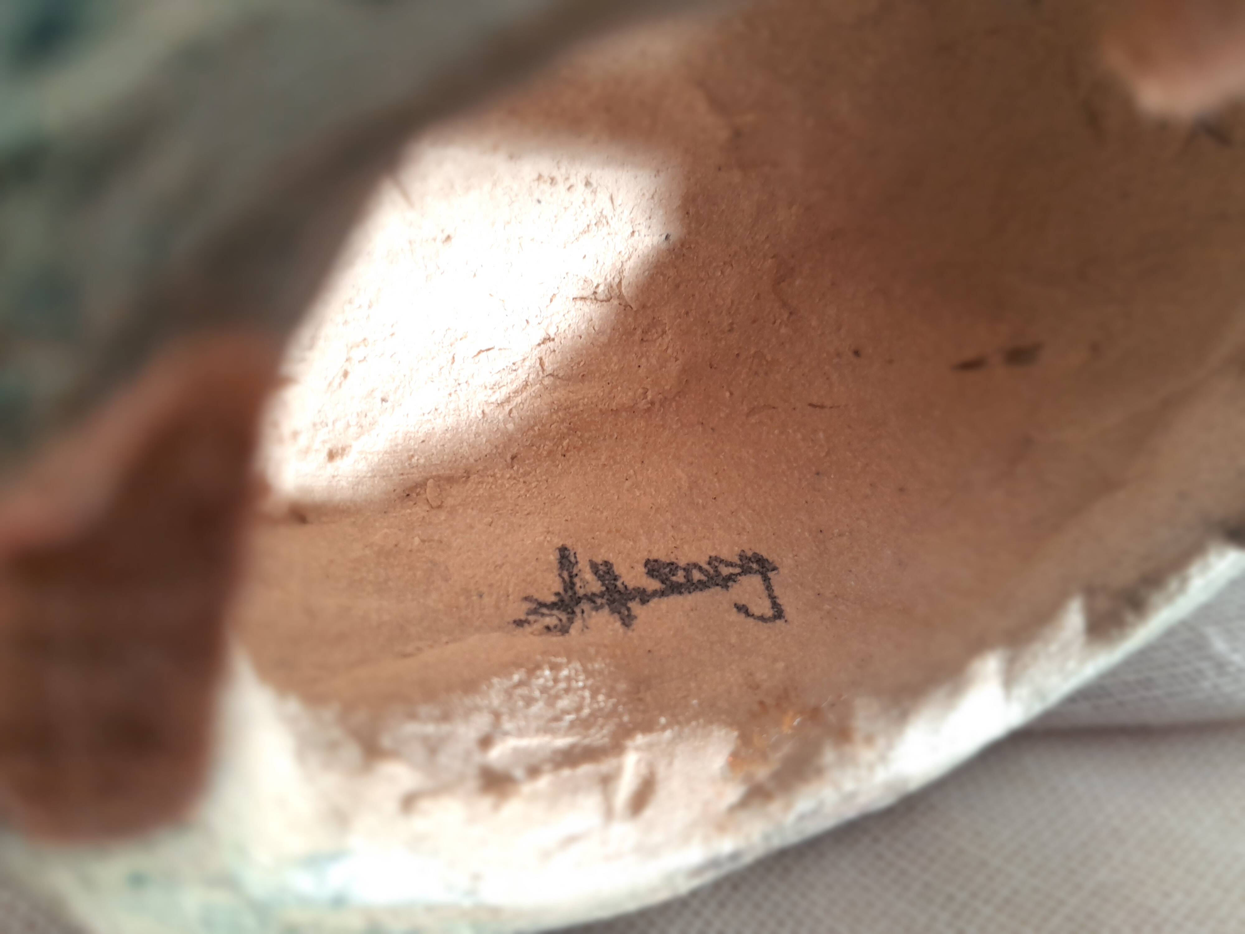 Signed bird sculpture