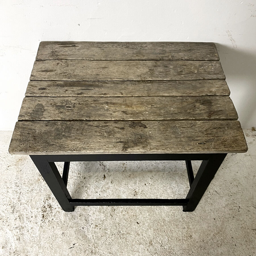 Old blackened wood work table and varnished top