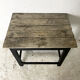 Old blackened wood work table and varnished top