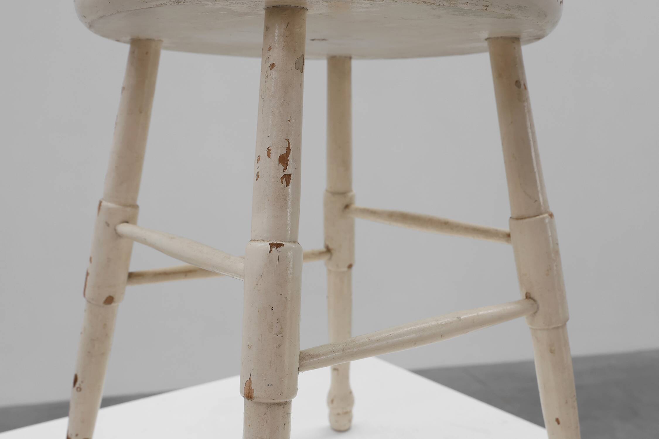 Rustic white wooden low farm stool, France ca. 1920