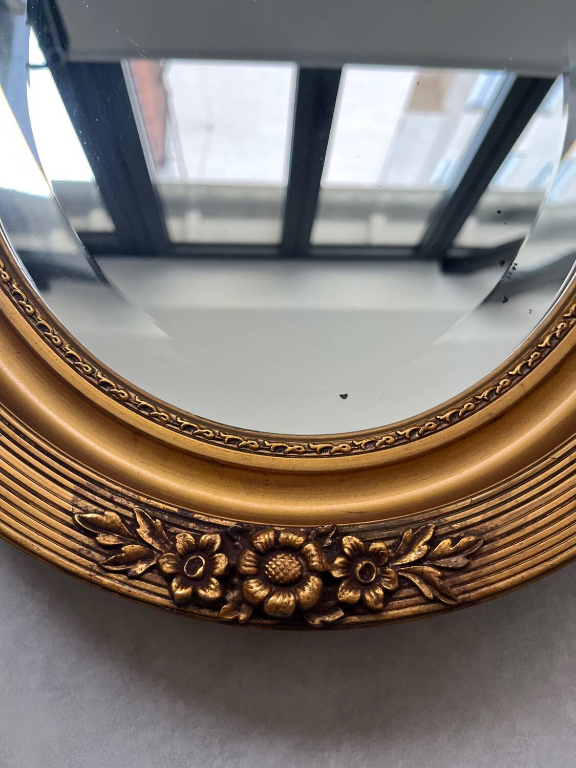 Oval gilt mirror and Art Deco trim