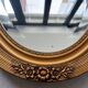 Oval gilt mirror and Art Deco trim