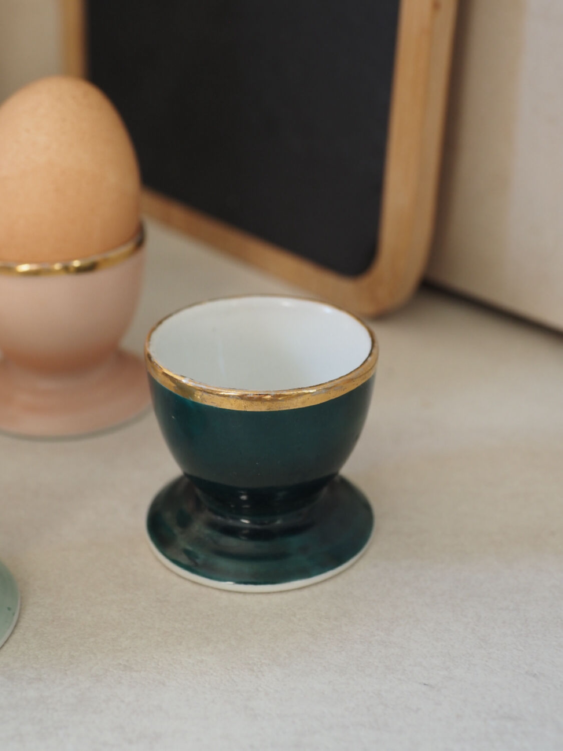 Four coloured egg cups with a golden rim from the 50s.