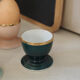 Four coloured egg cups with a golden rim from the 50s.
