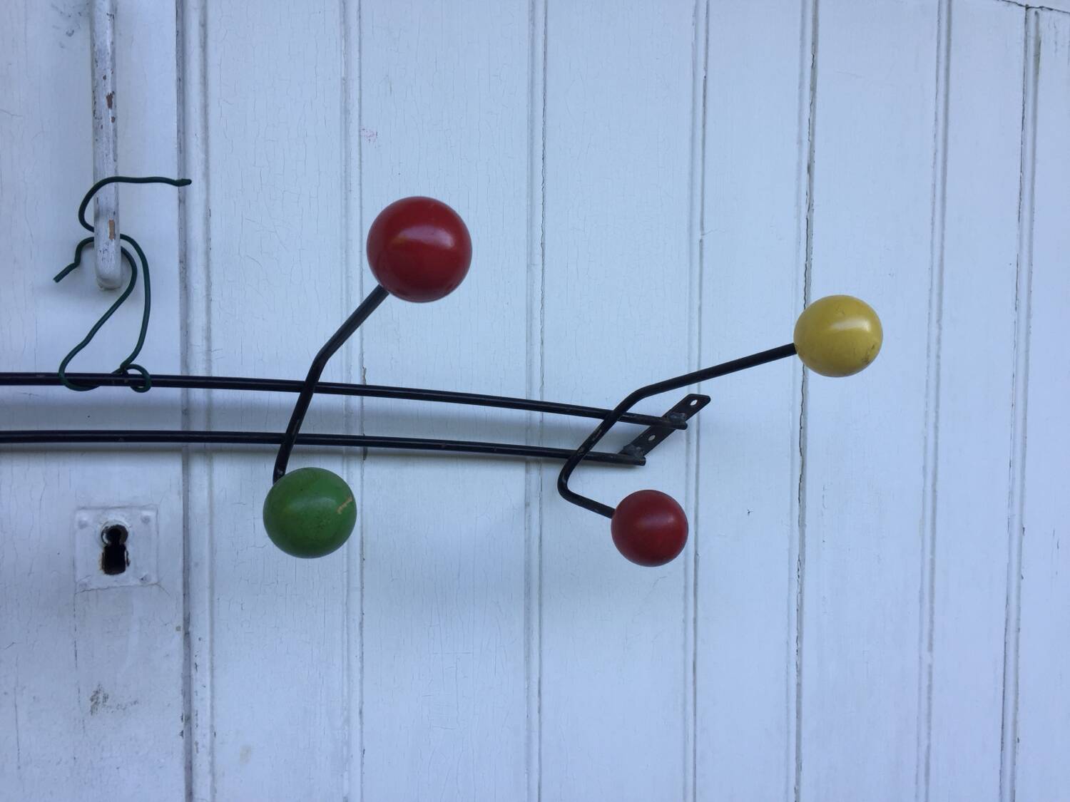 Roger Feraud wall-mounted wooden coat rack with colored balls, 1950