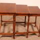 Nested tables in satin wood with brass inlays.