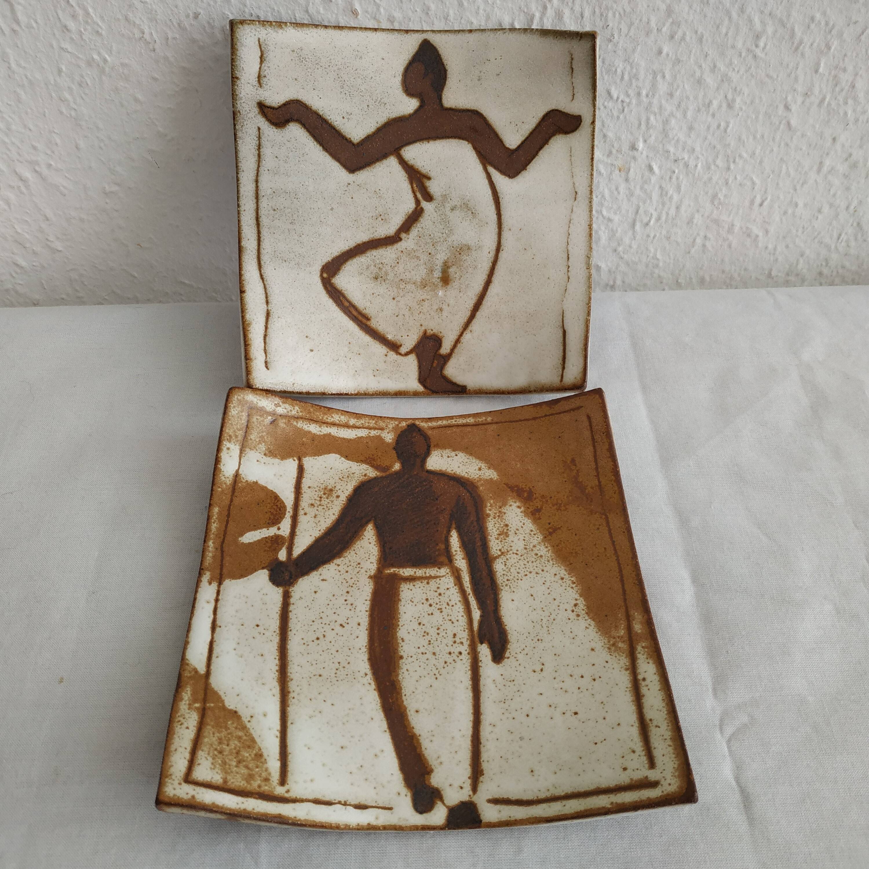 Two terracotta bowls with ethnic decoration and vintage signature.