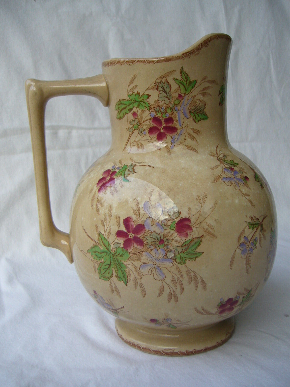 Antique pitcher decorated with flowers