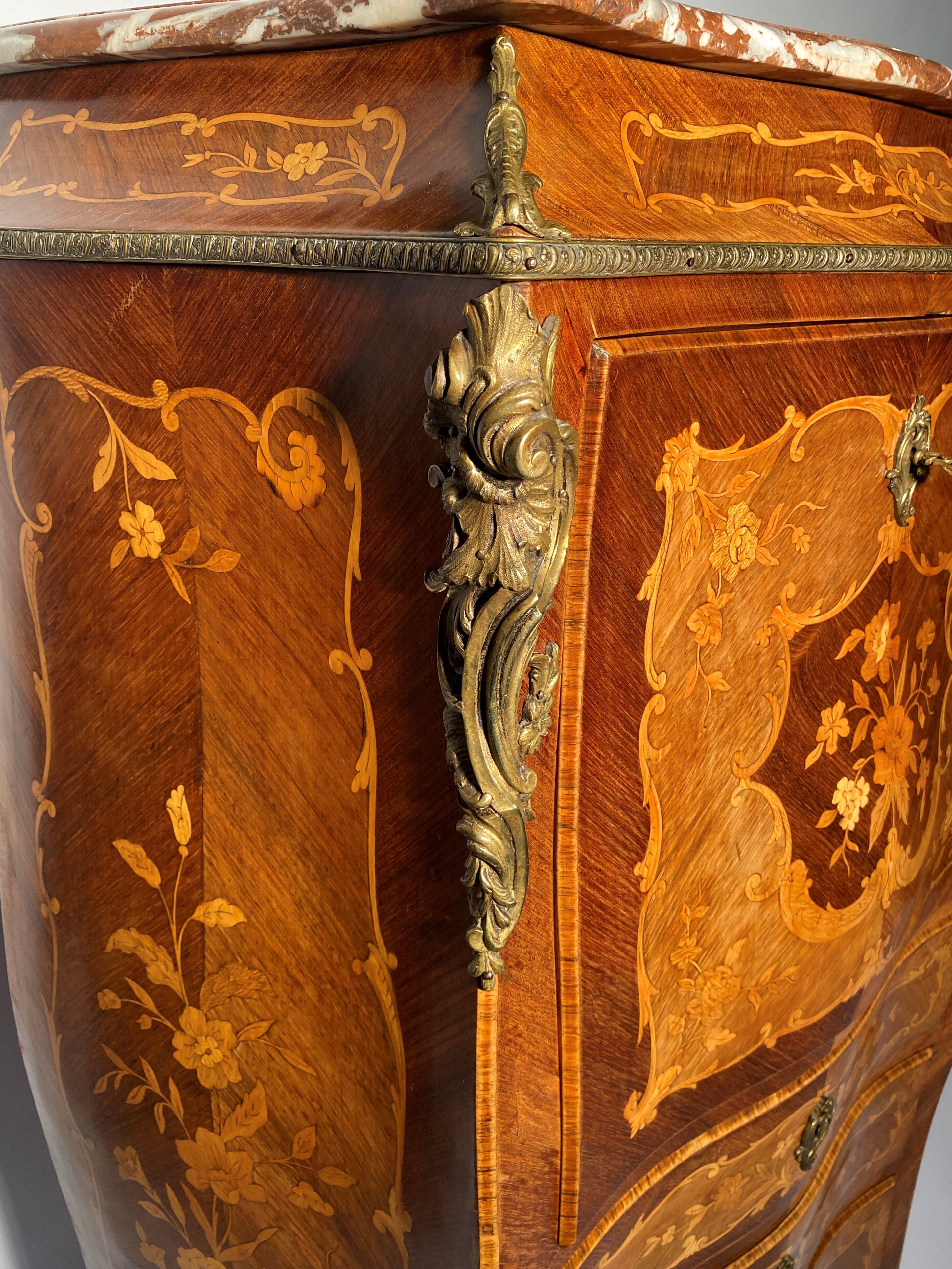 Curved secretary and inlaid with floral branches in Louis XV style