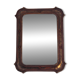 Italian sculpted mirror, patinated brown and gold wood, architectural frame from the 1960s.