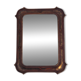 Italian sculpted mirror, patinated brown and gold wood, architectural frame from the 1960s.