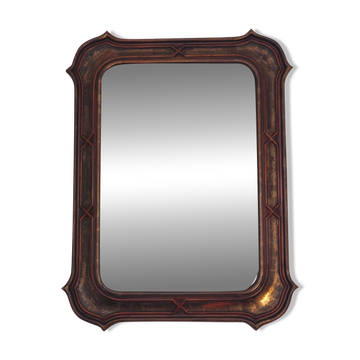Italian sculpted mirror, patinated brown and gold wood, architectural frame from the 1960s.