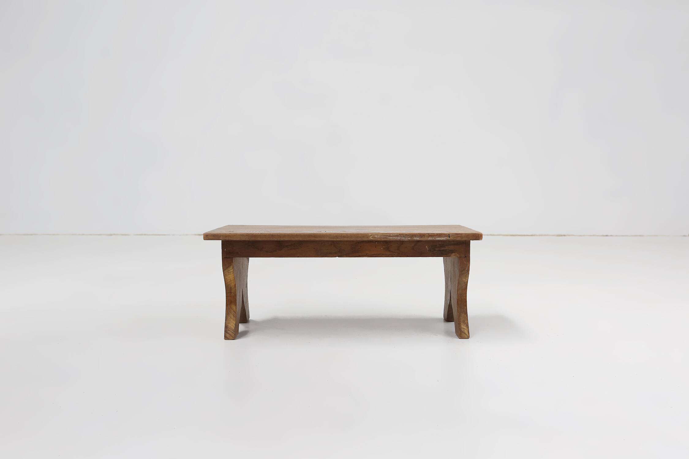 Small rustic wooden stool with curved base, France ca. 1900