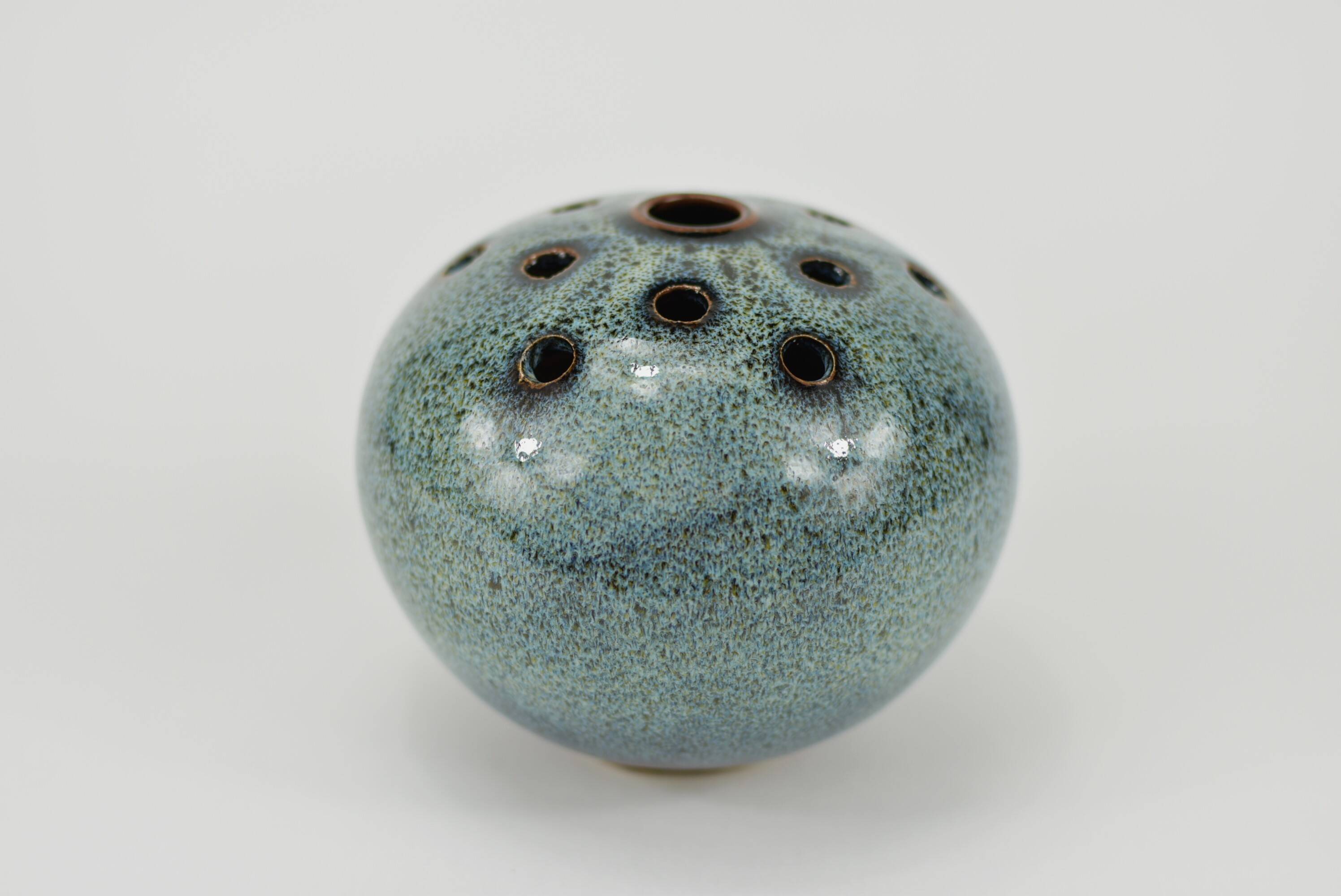 Vase with blue flowers.