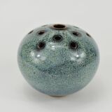 Vase with blue flowers.