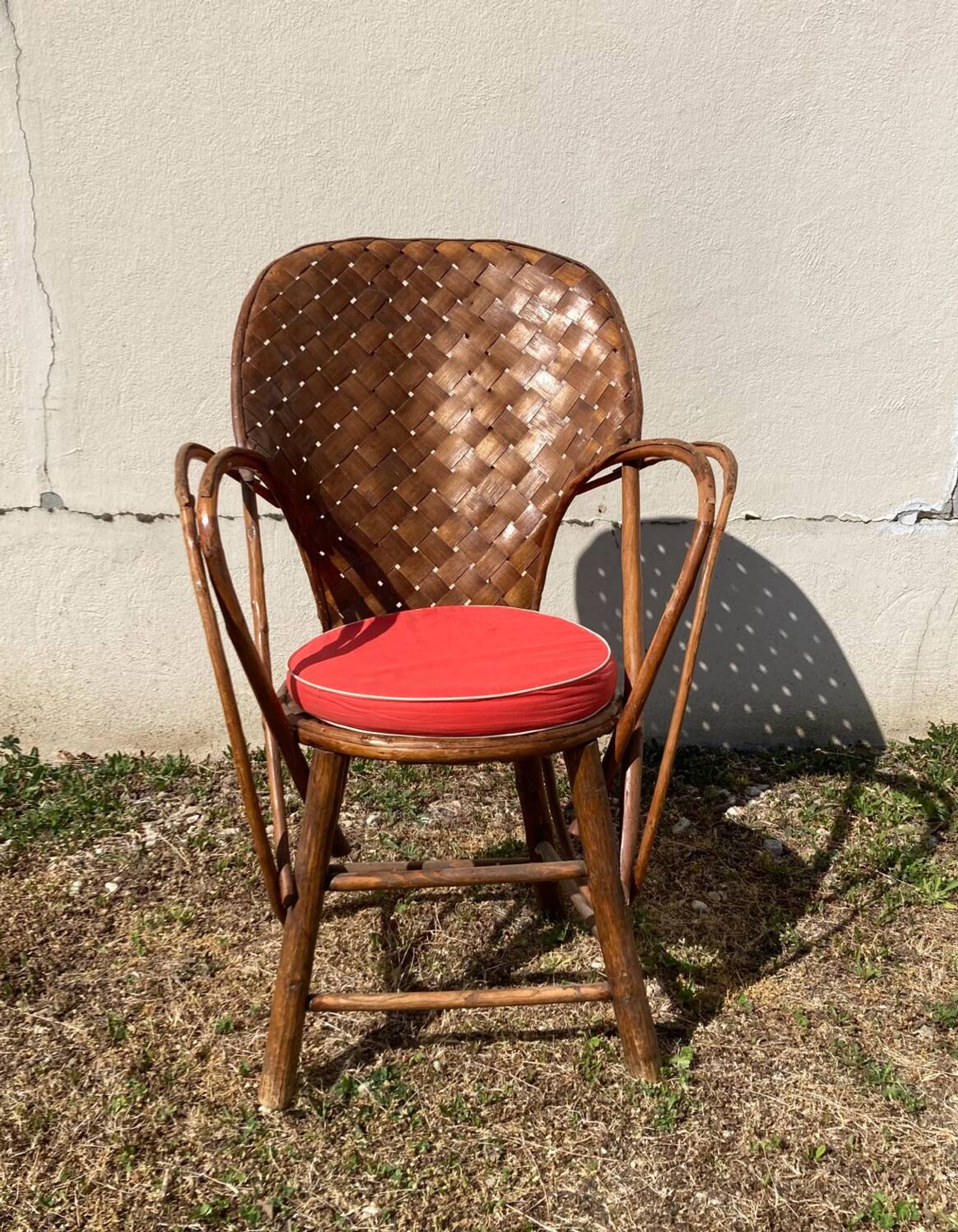 Vintage 1970s armchair in curved woven chestnut + seat cushion