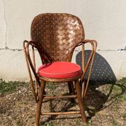 Vintage 1970s armchair in curved woven chestnut + seat cushion