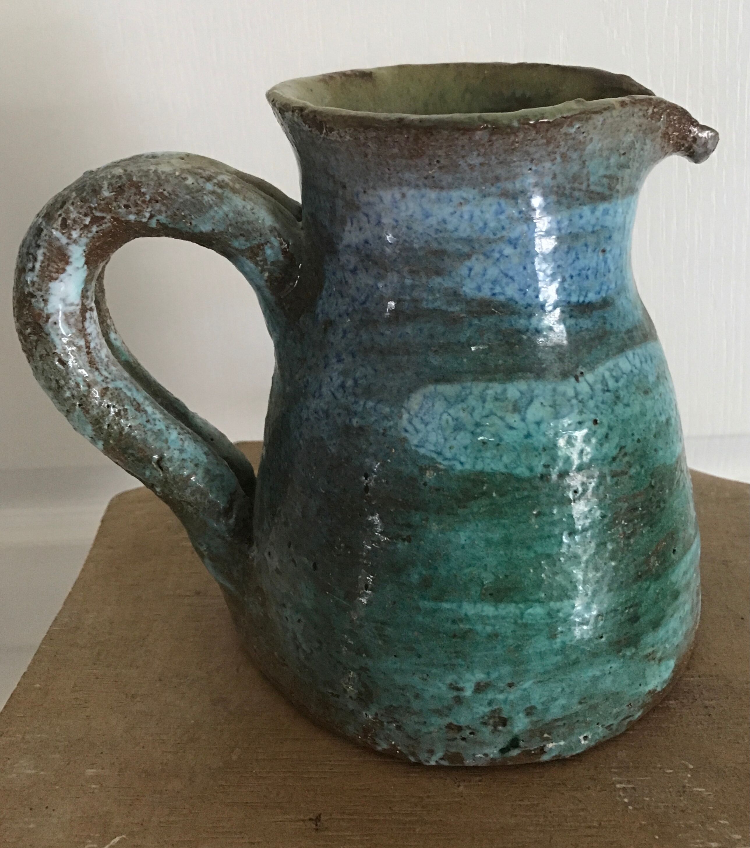 Vintage broc pitcher in enamelled sandstone with effect of blue shades, turquoise green signed