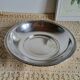 Shallow round metal plate with pearl row decoration.