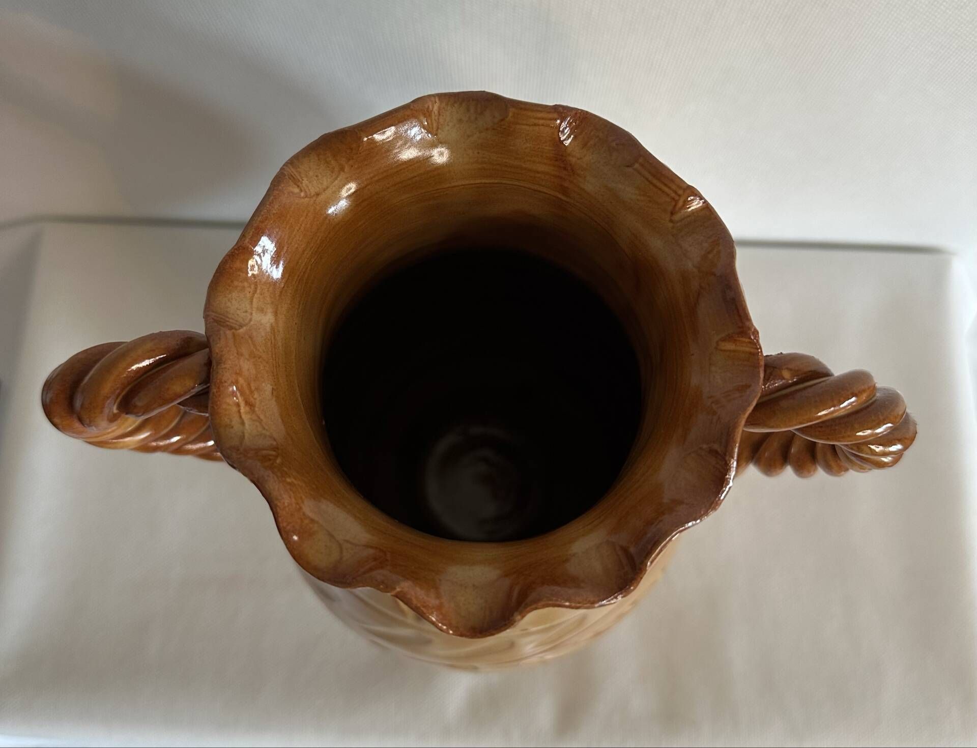Large antique ceramic vase with two twisted handles.