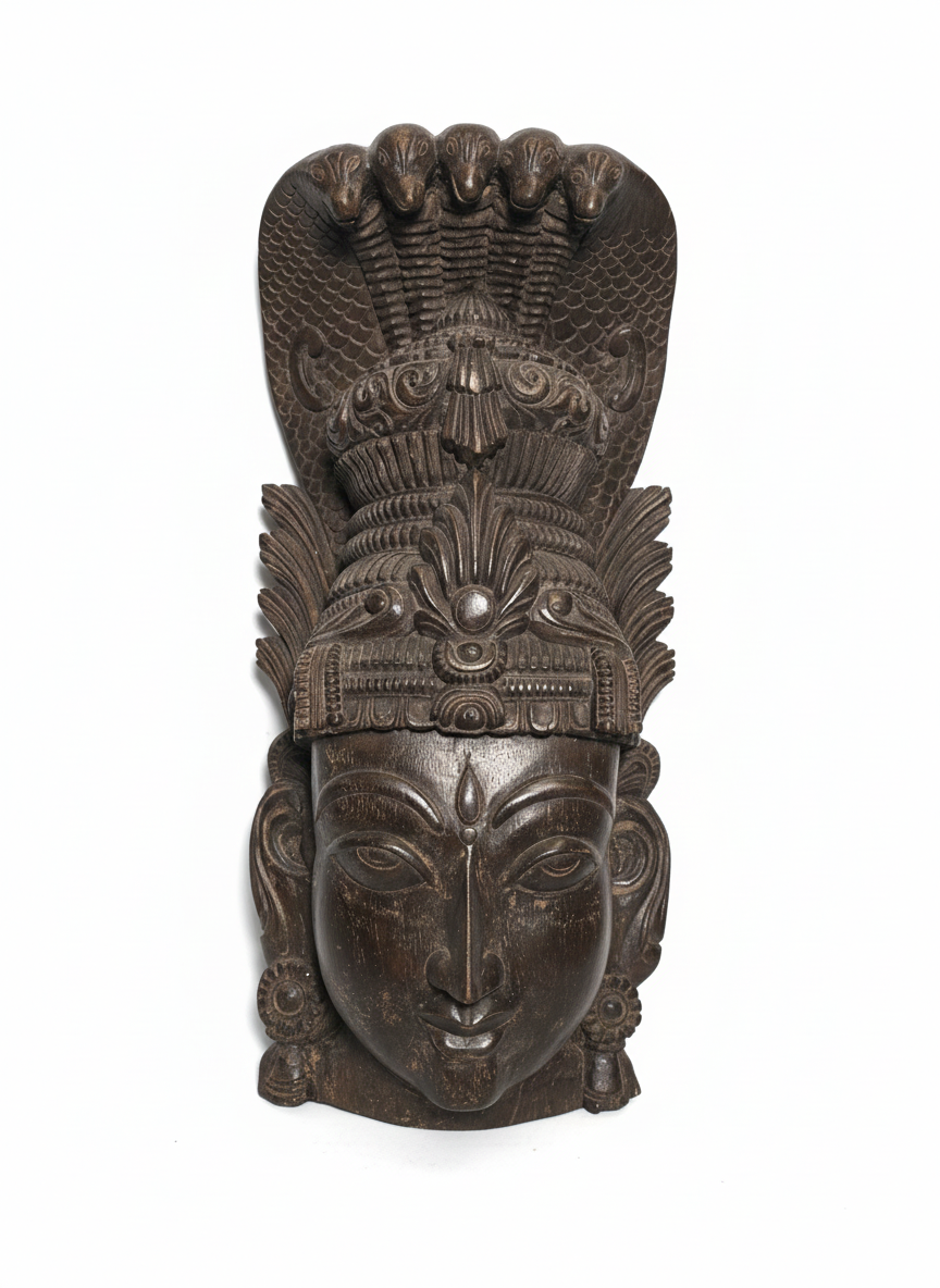 Ancient Indian carved wooden mask sculpture of a deity with a cobra.