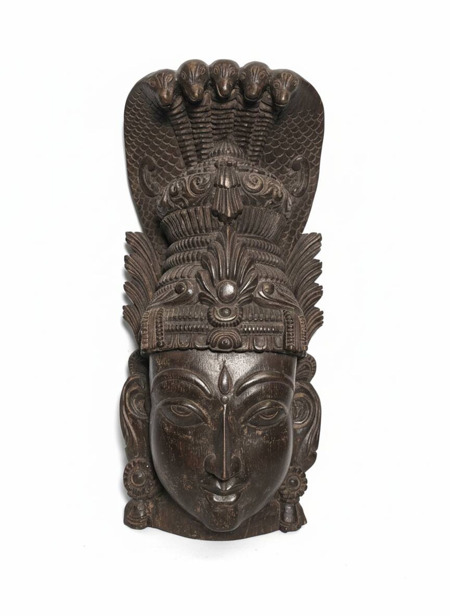 Ancient Indian carved wooden mask sculpture of a deity with a cobra.