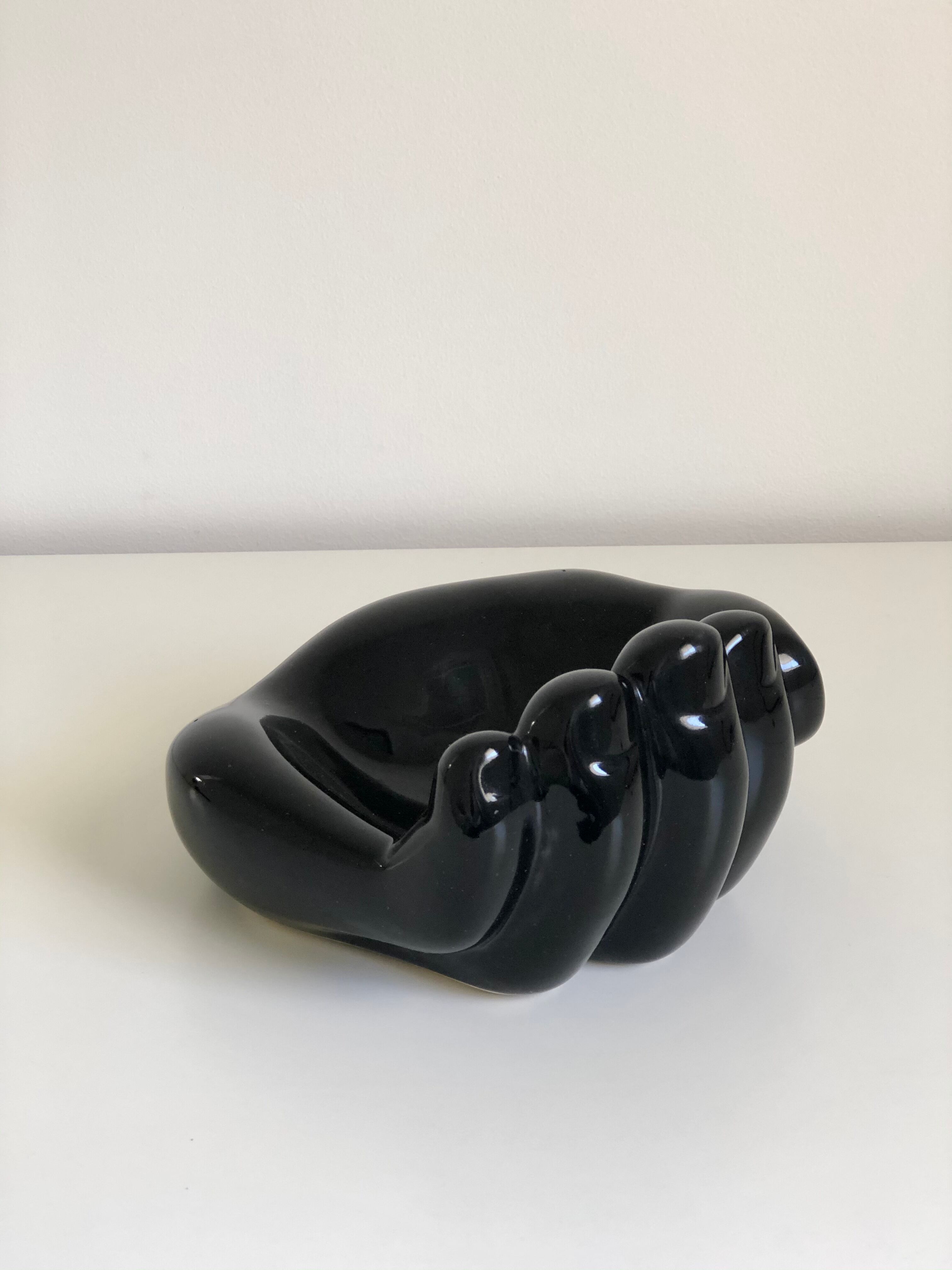 Empty black enamelled hand-shaped ceramic pocket, 1970