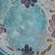 Blue floral glazed stoneware plate with a yellow rim.