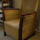 comfortable colonial-style armchair in rattan and mahogany
