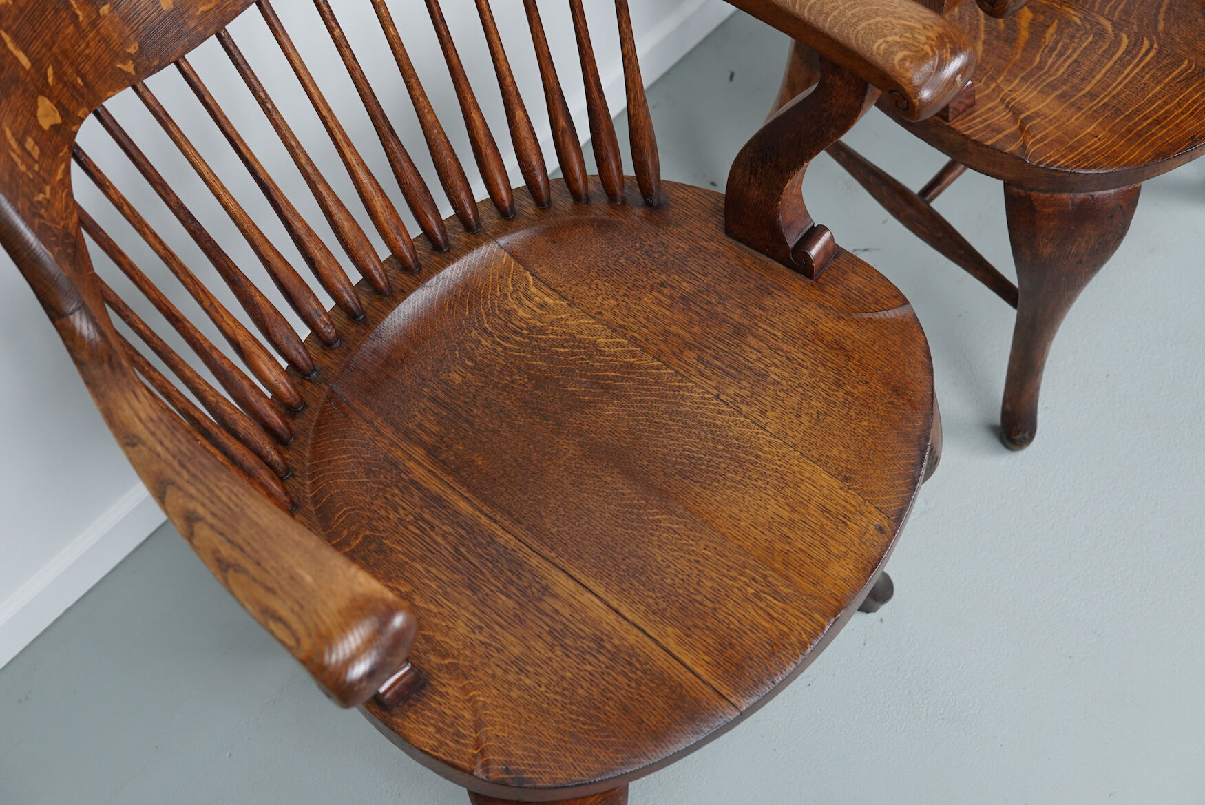 Pair of English Edwardian Oak Spindle Back Captains Office Desk Chairs