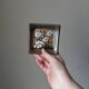 Handcrafted ceramic wall hanging with floral daisy decoration