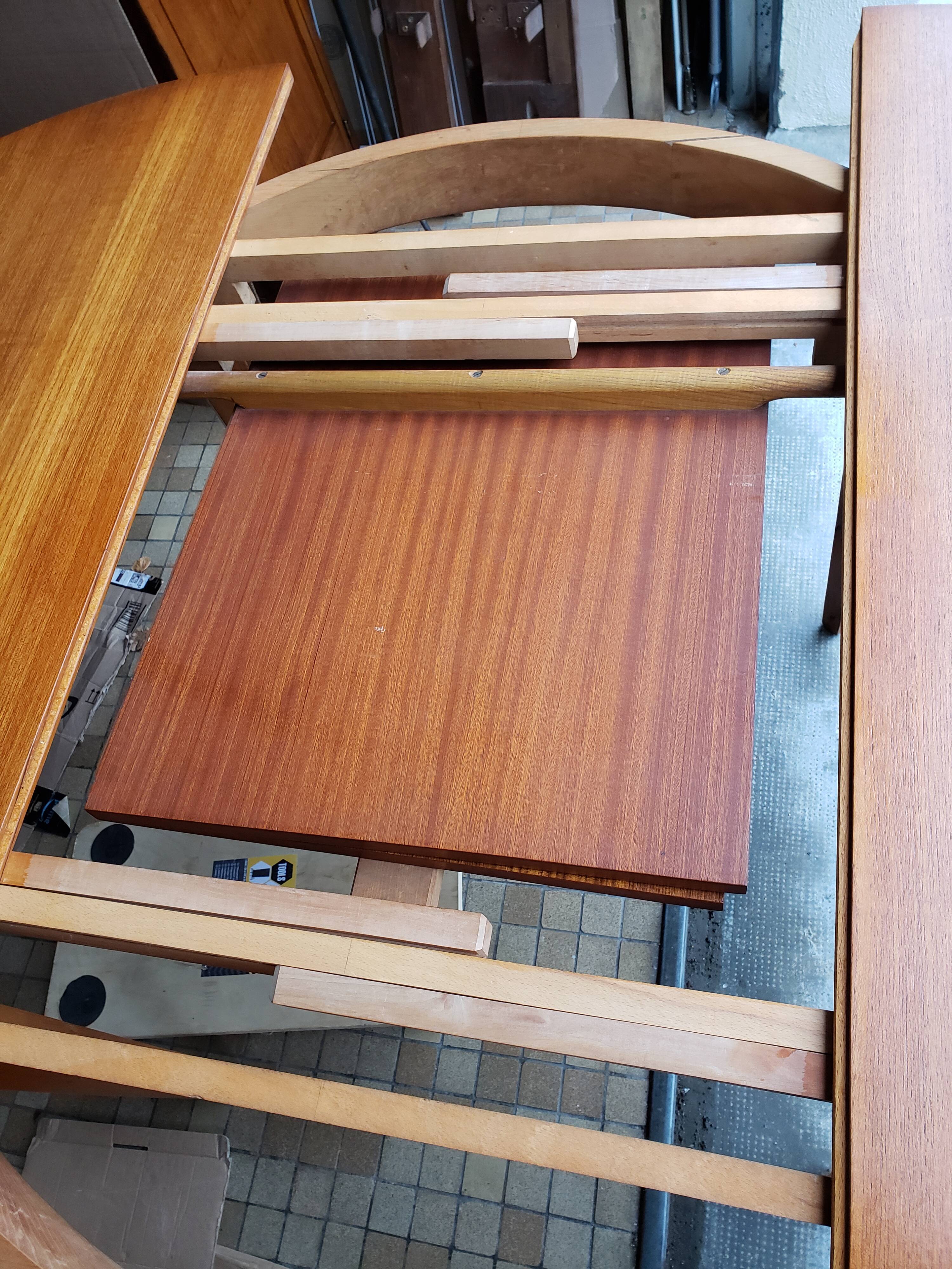 Round extendable teak dining table from the 60s