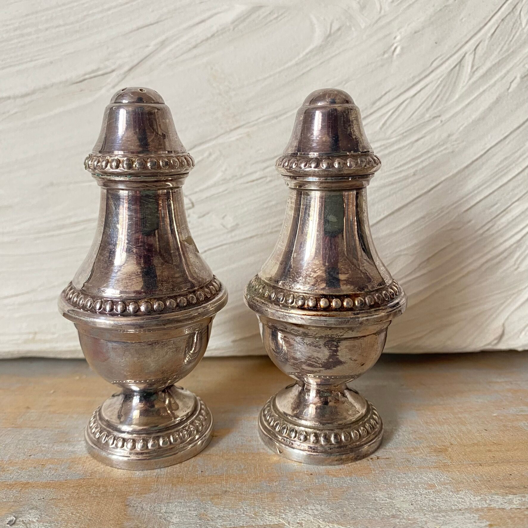 Silver-plated salt and pepper shakers, fluted, beaded decoration.