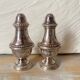 Silver-plated salt and pepper shakers, fluted, beaded decoration.