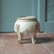 Solid wood plant stand with Louis XV style palm leaf motifs.