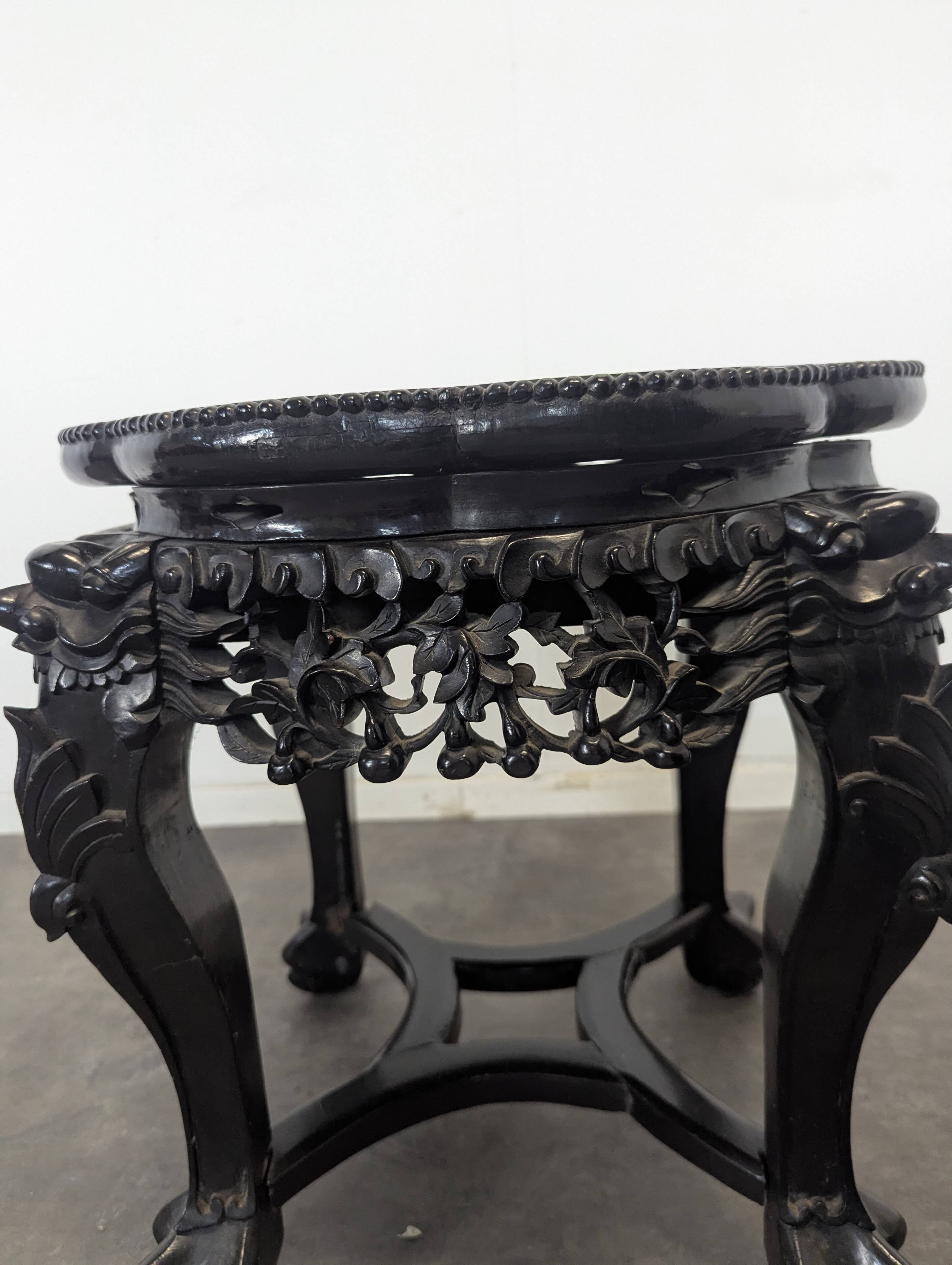 Side table with a wooden frame and marble top.