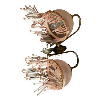 Pair of wall sconces in pink glass and pendants.