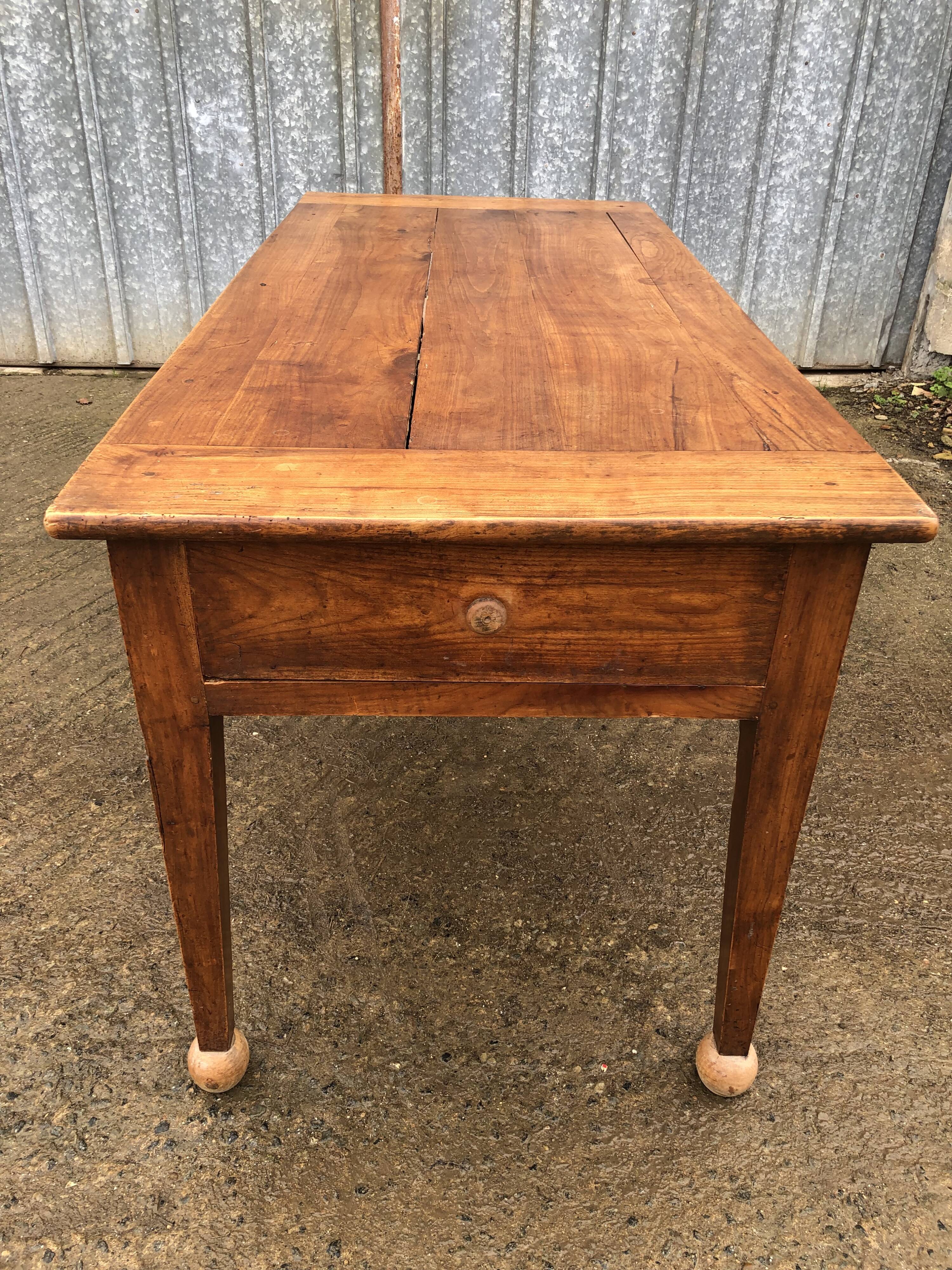 Antique solid cherry farmhouse table with 2 end drawers and 1 pull-out.