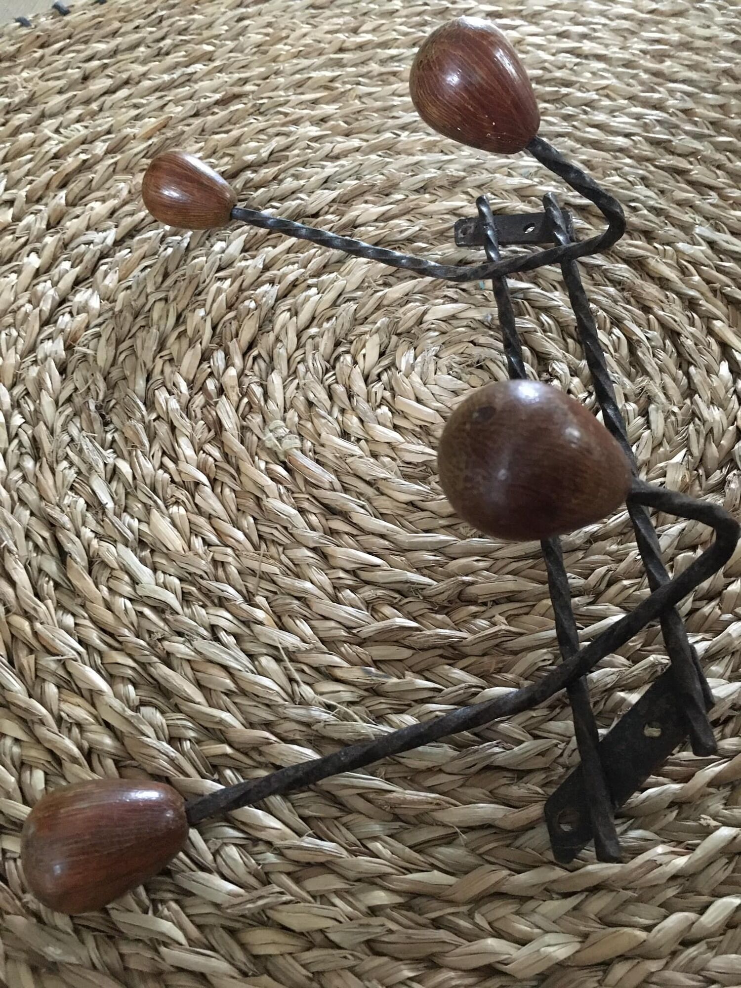 Old wrought iron coat rack. 4 hooks in chestnut wood