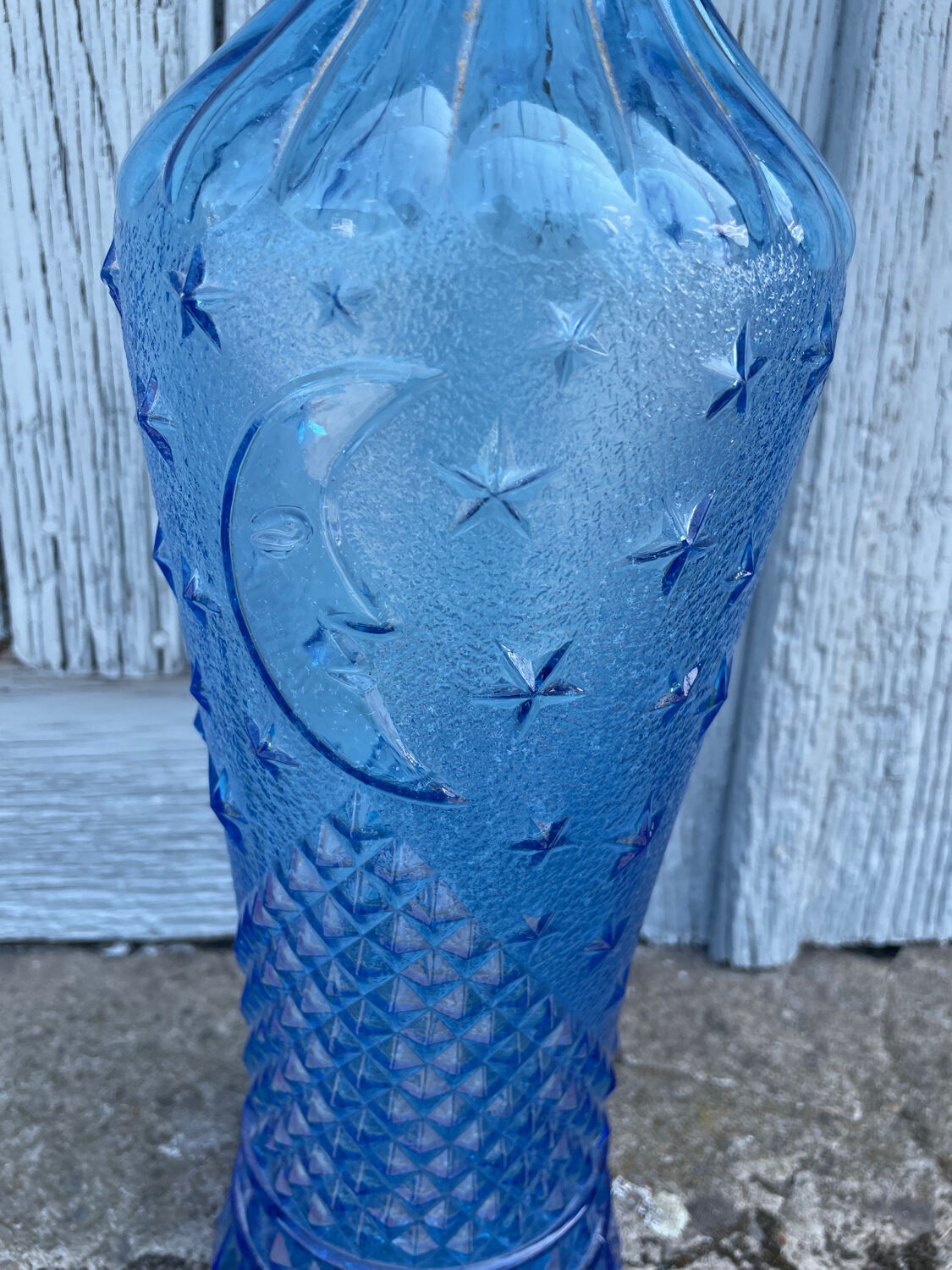 Blue glass decanter with a moon star motif
