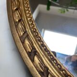 Large oval mirror in wood gilded with fine gold