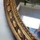 Large oval mirror in wood gilded with fine gold