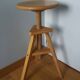 Tripod stool with a screw.