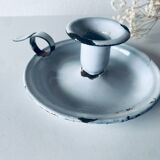 Old candle holder in white enameled metal