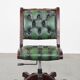 English Chesterfield office chair in green leather, height adjustable on casters