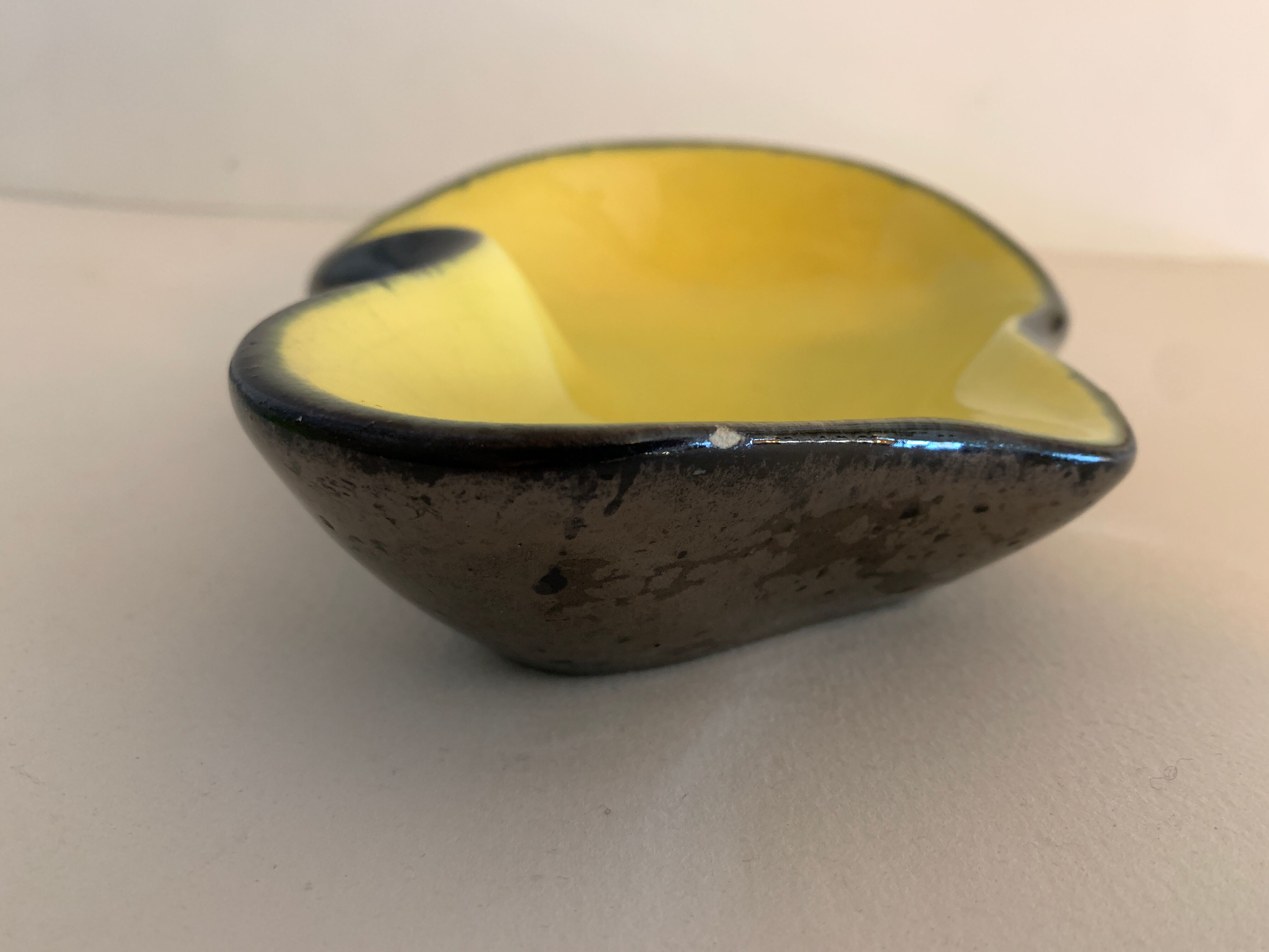 Yellow and black ceramic ashtray