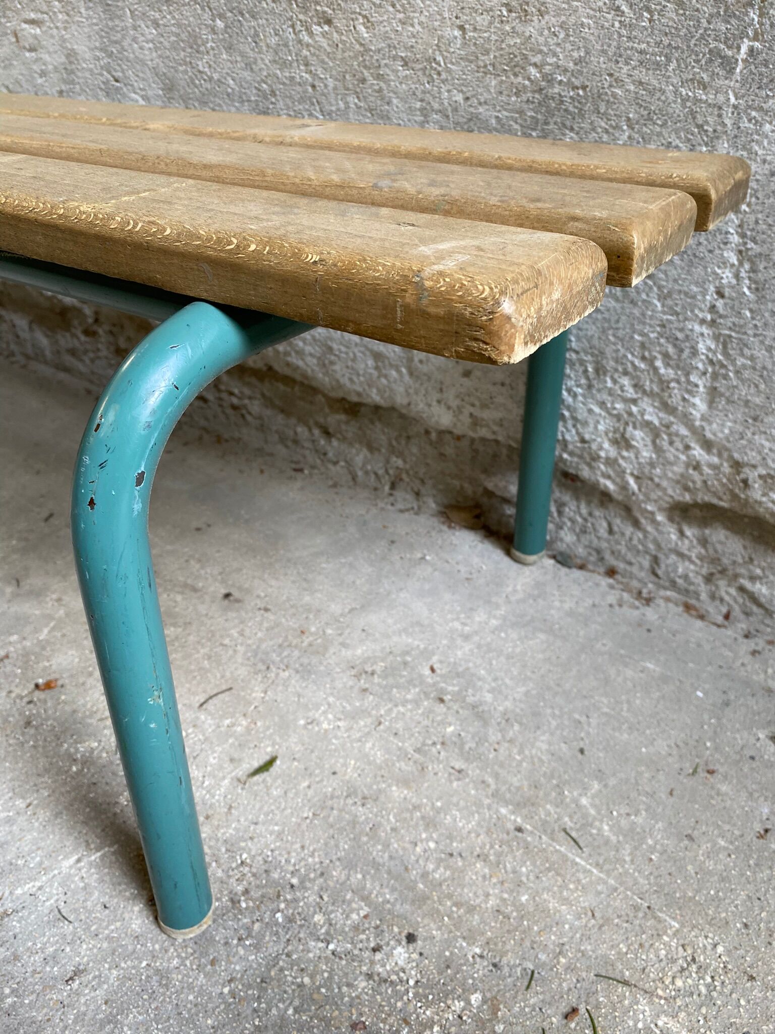 Vintage wood kindergarten bench and tubular structure in long