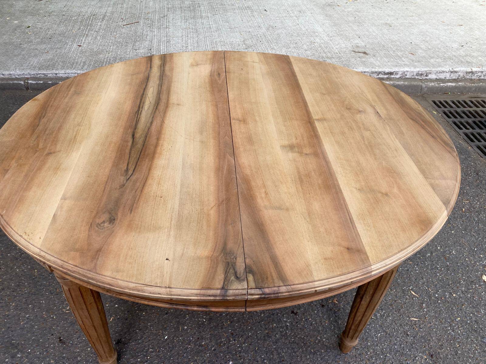 Art Deco round extendable dining table stripped in solid walnut from the 1920s.