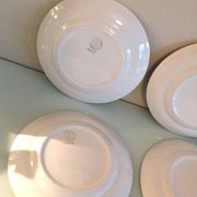 Set of six flat plates and one Moulin des Loups bowl, green tablecloth model/1950s-1960s